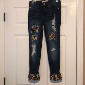 KanCan leopard distressed skinny jeans.